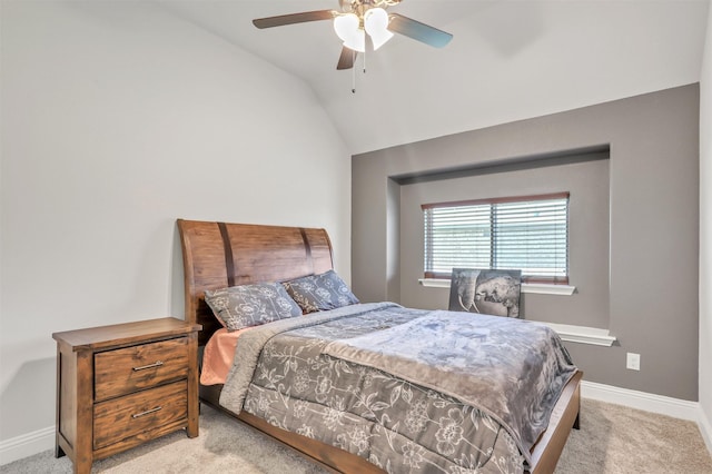 bedroom with light colored carpet, vaulted ceiling, and ceiling fan