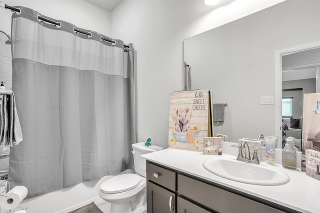 full bathroom featuring shower / bath combo with shower curtain, toilet, and vanity