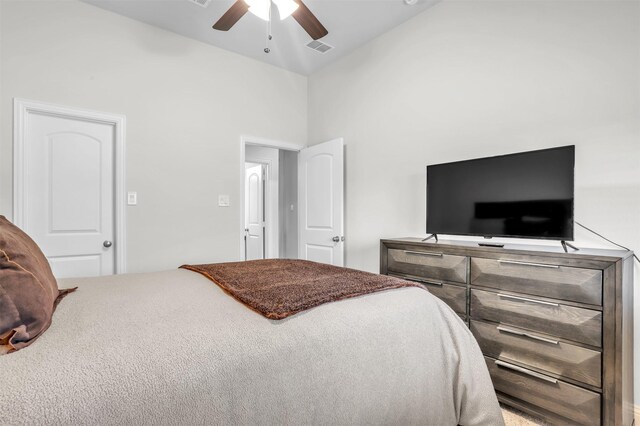 bedroom with ceiling fan and high vaulted ceiling