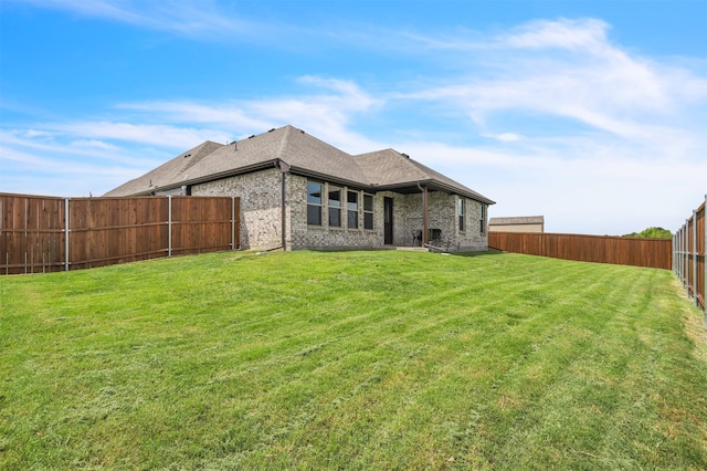 rear view of property with a lawn