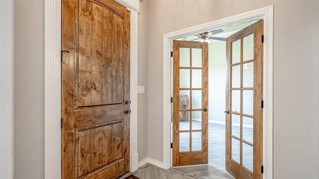 entryway featuring french doors, light wood-type flooring, and ceiling fan