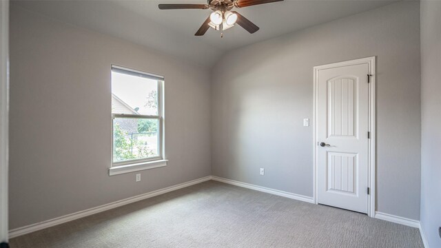 carpeted empty room featuring ceiling fan