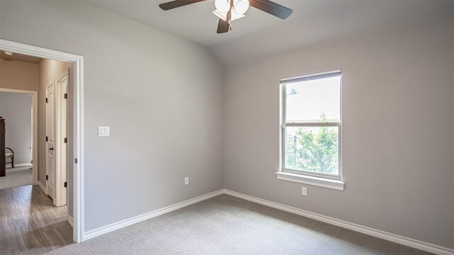 carpeted spare room featuring ceiling fan