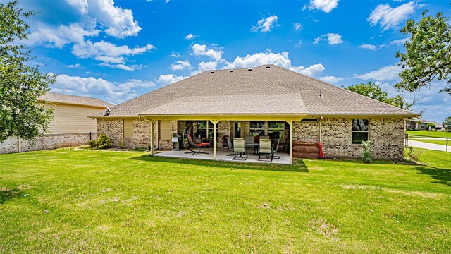 rear view of house with a yard and a patio area