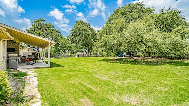 view of yard with a patio and a playground