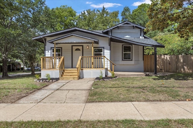 bungalow-style home with a front yard and a porch