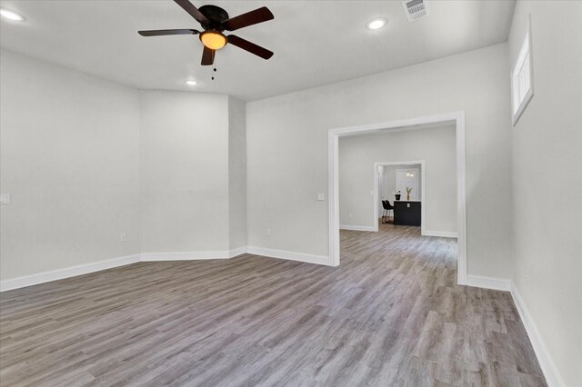 unfurnished room with recessed lighting, visible vents, baseboards, and wood finished floors