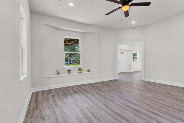 254 19th St SE, Paris, TX 75460 - spare room with wood finished floors, healthy amount of natural light, a ceiling fan, baseboards, and recessed lighting