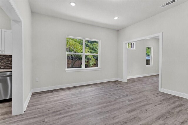 254 19th St SE, Paris, TX 75460 - unfurnished living room featuring wood finished floors, recessed lighting, and baseboards