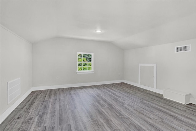 bonus room featuring wood-type flooring and vaulted ceiling