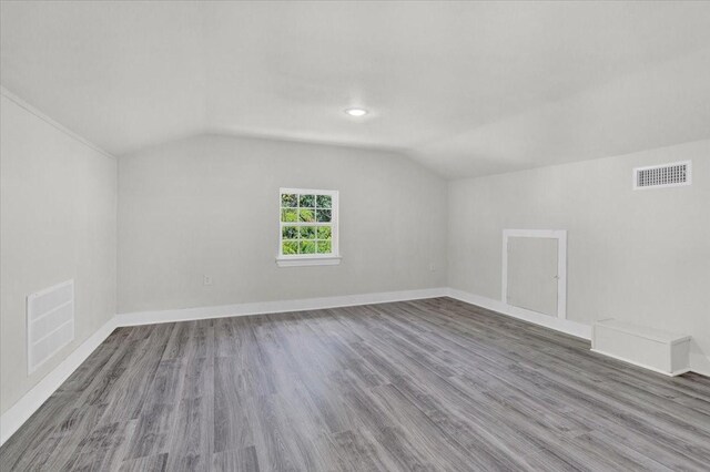 254 19th St SE, Paris, TX 75460 - additional living space featuring vaulted ceiling, wood finished floors, baseboards, and recessed lighting