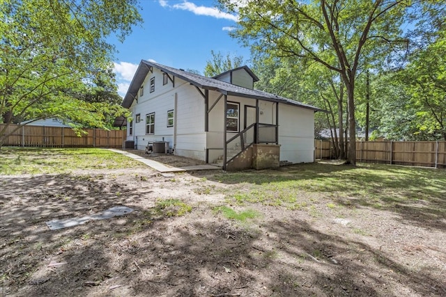 exterior space with a lawn and central air condition unit