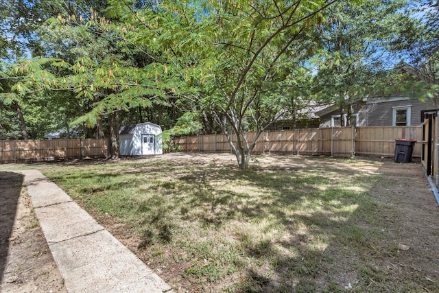 view of yard with a storage unit, an outdoor structure, and a fenced backyard