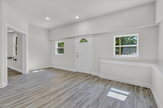 entryway featuring recessed lighting, wood finished floors, and baseboards