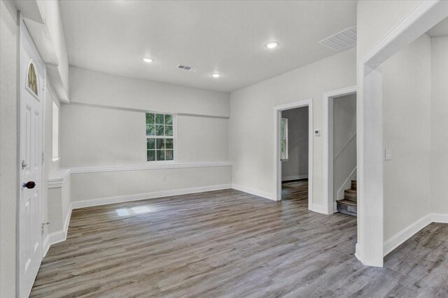 254 19th St SE, Paris, TX 75460 - empty room featuring wood finished floors, stairway, baseboards, and recessed lighting