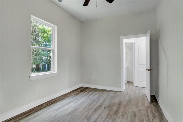 254 19th St SE, Paris, TX 75460 - unfurnished room with a ceiling fan, light wood-style floors, and baseboards