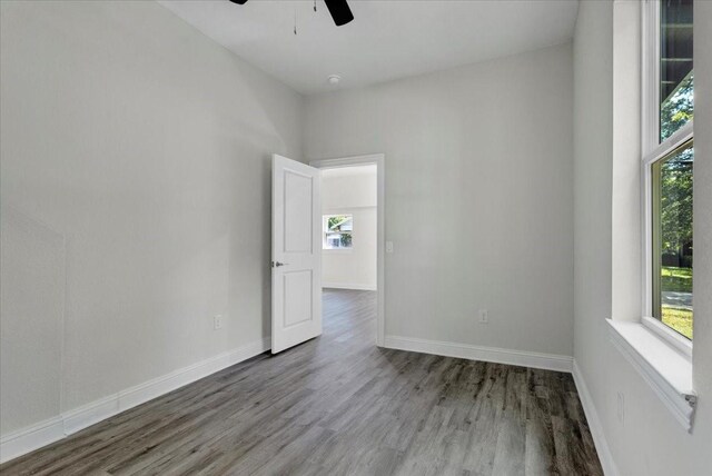 254 19th St SE, Paris, TX 75460 - empty room with a ceiling fan, plenty of natural light, wood finished floors, and baseboards
