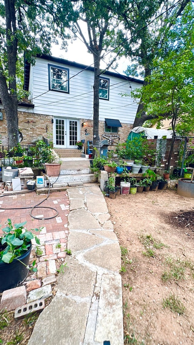 rear view of house featuring a patio area and french doors