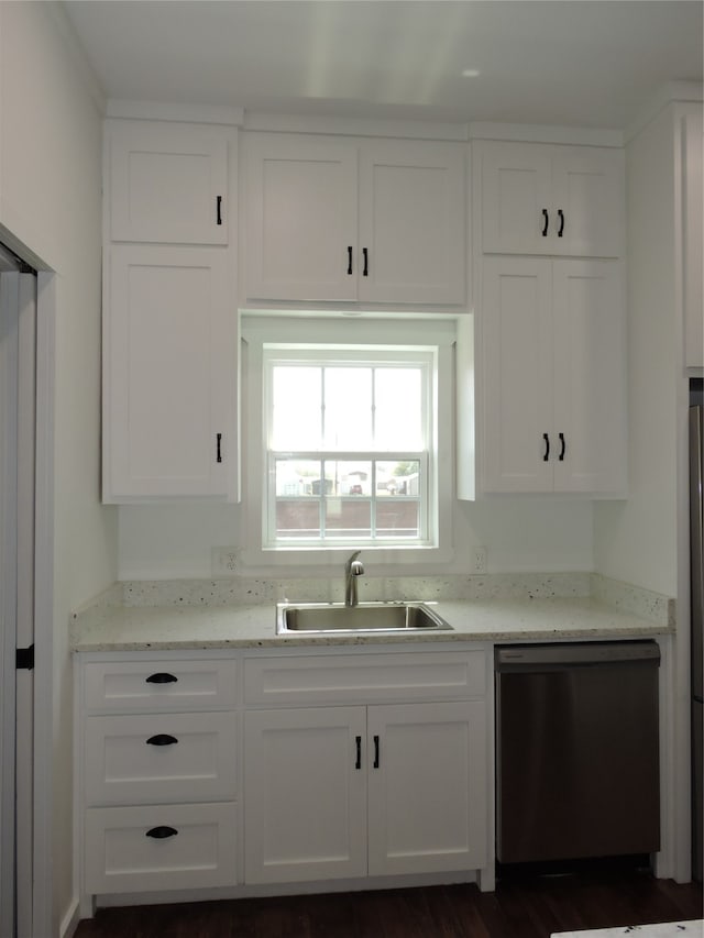 kitchen featuring stainless steel dishwasher, white cabinetry, dark hardwood / wood-style flooring, sink, and light stone counters