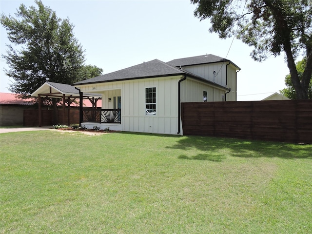 back of house with a lawn