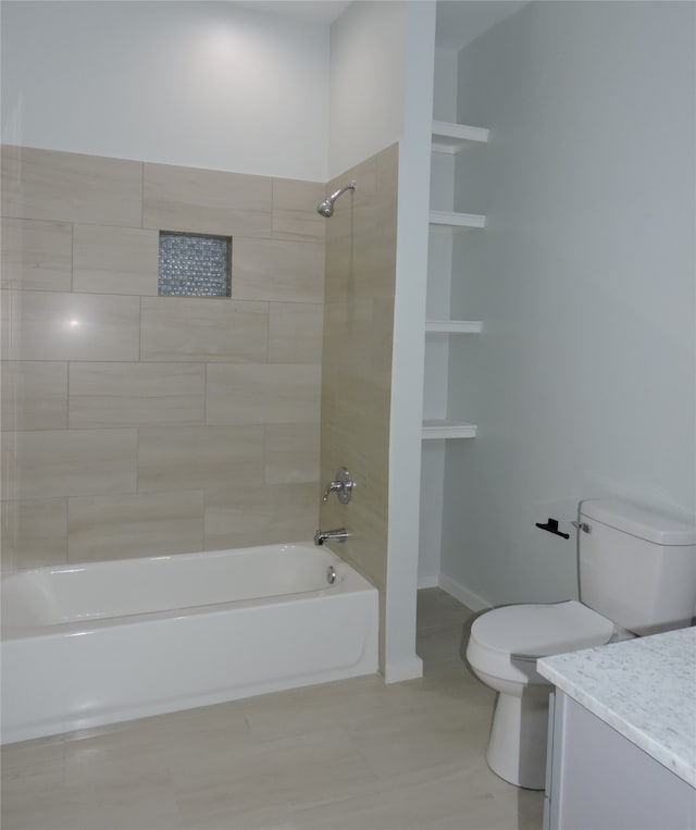 full bathroom featuring vanity, toilet, tiled shower / bath, and tile patterned flooring