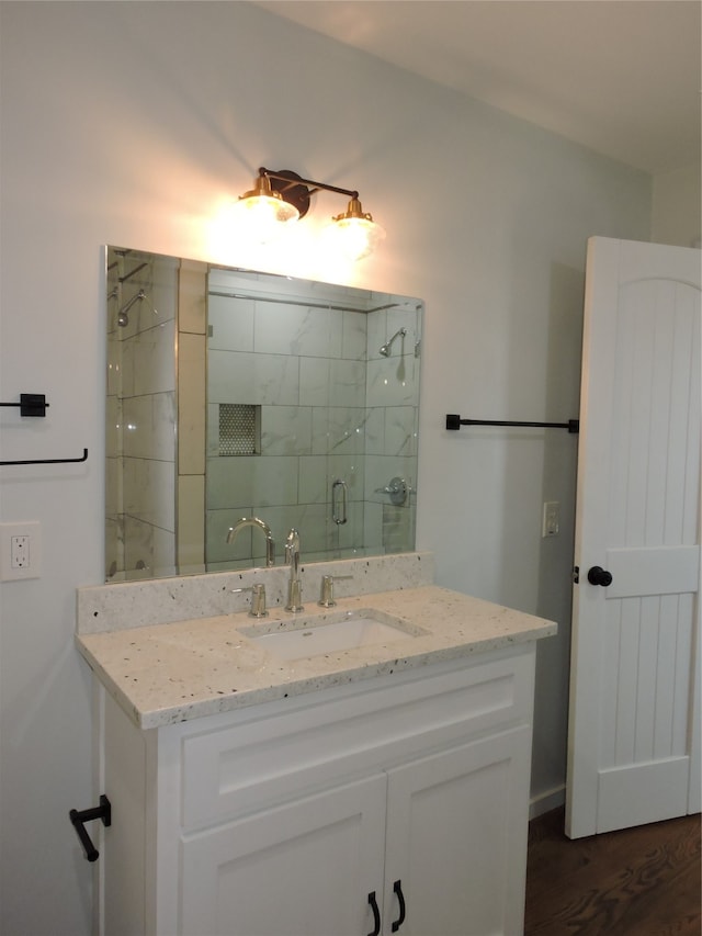 bathroom with hardwood / wood-style floors and vanity