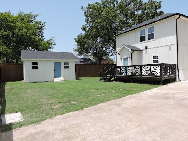 view of yard with a deck and an outdoor structure