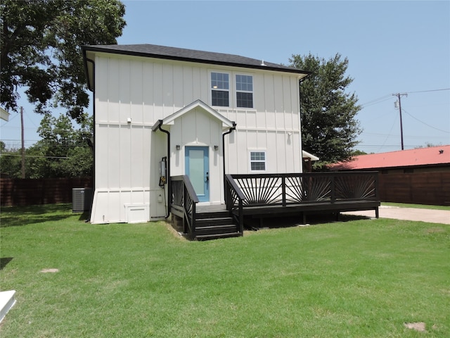 rear view of house featuring a yard, a wooden deck, and central AC unit