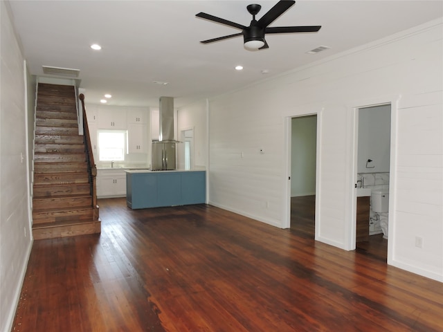 unfurnished living room featuring ornamental molding, sink, ceiling fan, and dark hardwood / wood-style floors