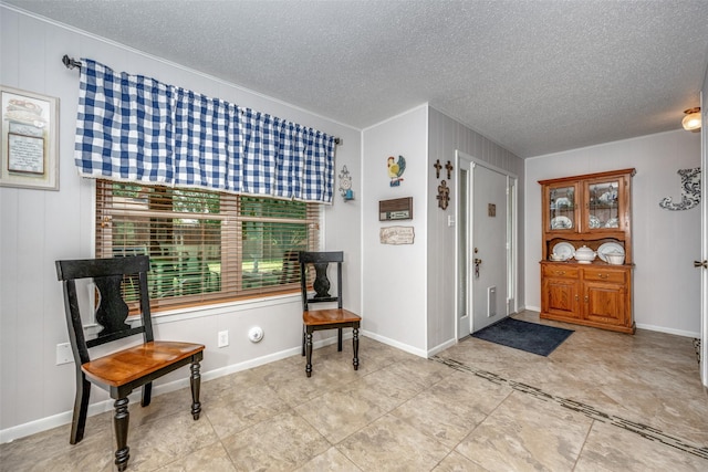 entrance foyer with a textured ceiling and baseboards