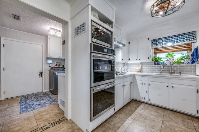 kitchen with light tile patterned flooring, sink, and white cabinets