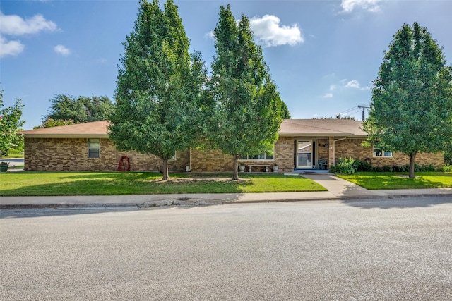 ranch-style house with brick siding and a front yard