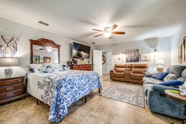 bedroom featuring light tile patterned flooring, a textured ceiling, and ceiling fan