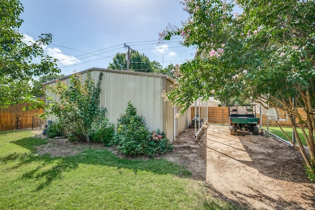 view of yard with a fenced backyard and an outdoor structure