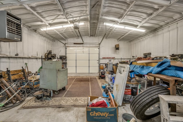 garage with a garage door opener, metal wall, and a heating unit