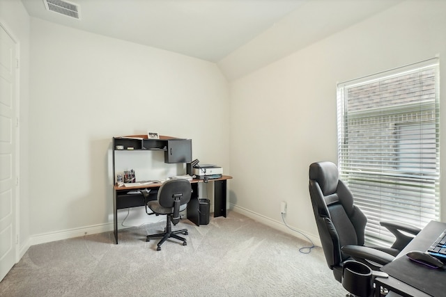 carpeted home office featuring lofted ceiling and a healthy amount of sunlight