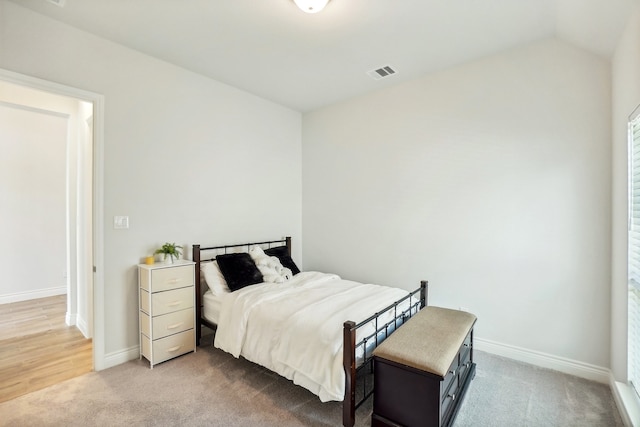 bedroom featuring vaulted ceiling and hardwood / wood-style floors