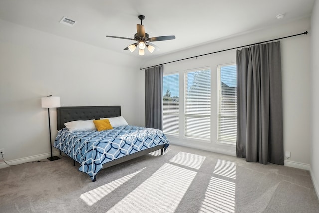 bedroom with ceiling fan and light colored carpet