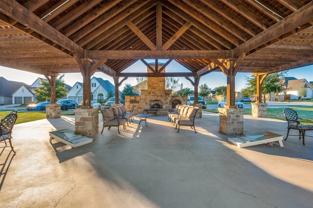 view of patio with a gazebo and an outdoor stone fireplace