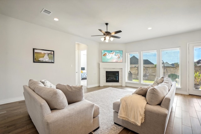 living room with wood-type flooring and ceiling fan