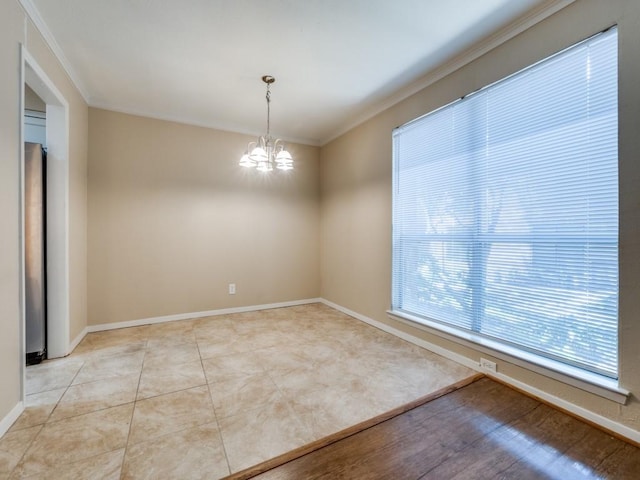 tiled empty room featuring a chandelier and ornamental molding