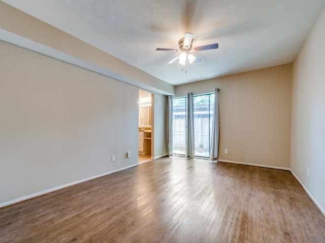 empty room featuring ceiling fan and light hardwood / wood-style flooring