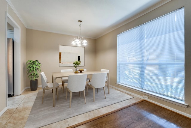 unfurnished dining area featuring light hardwood / wood-style flooring, an inviting chandelier, and ornamental molding