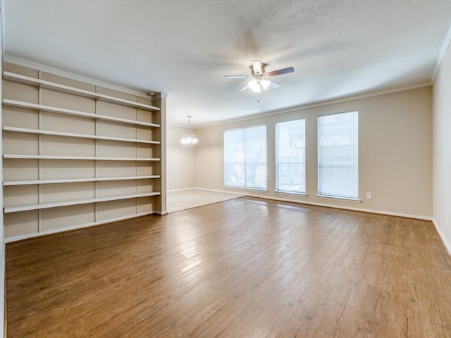 unfurnished living room featuring hardwood / wood-style floors, ceiling fan with notable chandelier, and ornamental molding