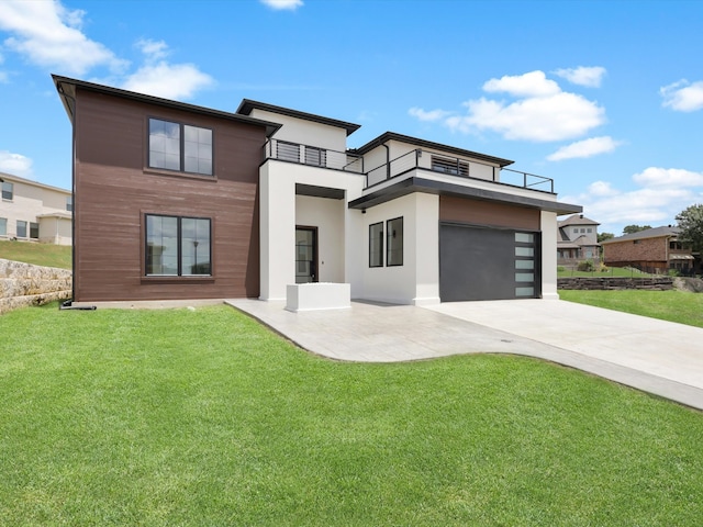 modern home with a balcony, a garage, and a front lawn