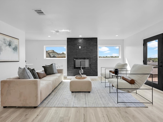 living room with a fireplace and light hardwood / wood-style flooring