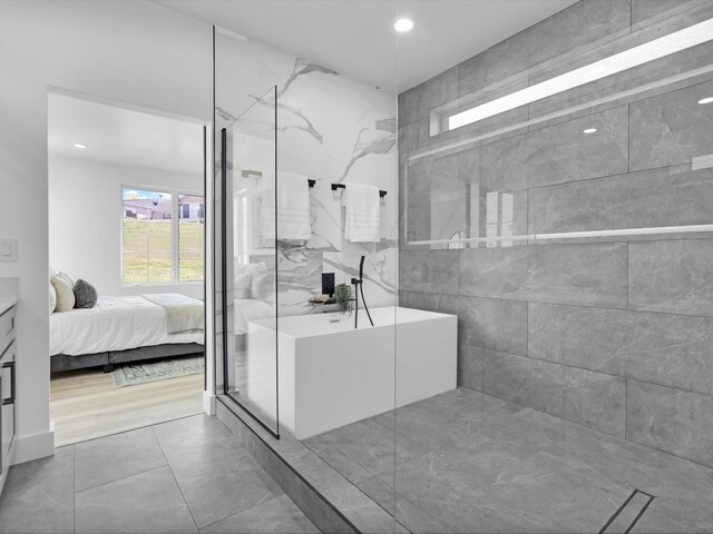 bathroom featuring hardwood / wood-style flooring, tile walls, vanity, and an enclosed shower