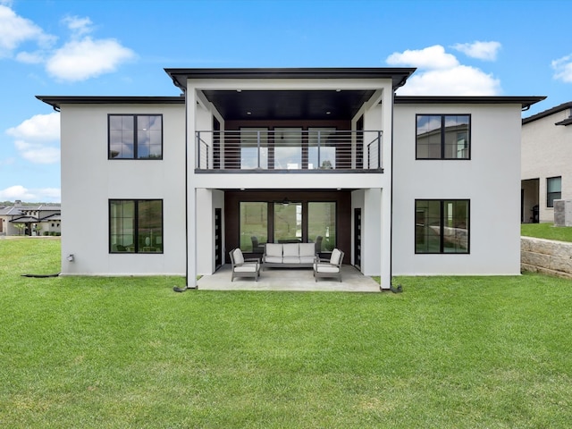 back of property featuring a patio, a balcony, outdoor lounge area, and a yard