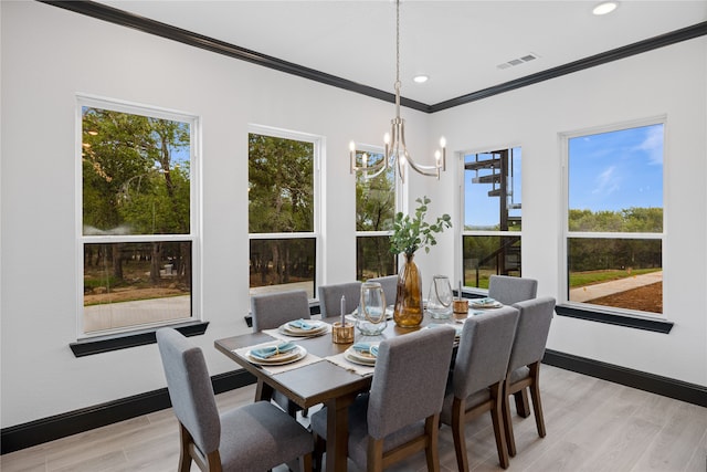 dining space with a notable chandelier, light hardwood / wood-style flooring, and ornamental molding