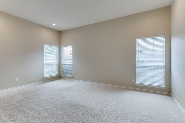 unfurnished room featuring light colored carpet